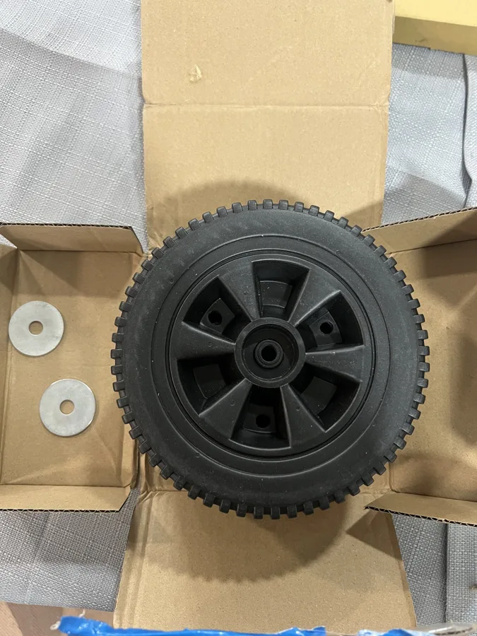 Real J&J inventory: a wheel and hardware in an open cardboard box